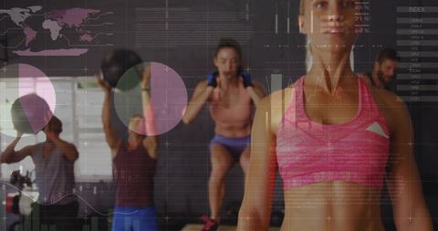 Fit woman leading high-energy group training with medicine balls in bright gym studio