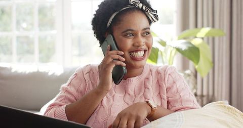 Smiling Woman Enjoys Relaxed Phone Call at Home