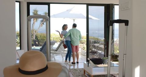 Senior Couple Enjoying Ocean View from Modern Living Area