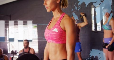 Fit woman lifting barbell in gym with global data overlay for strength training