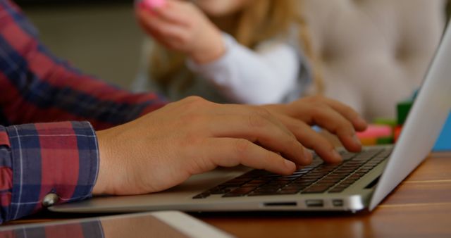 Remote Working Father Typing on Laptop with Young Child in Background - Download Free Stock Images Pikwizard.com