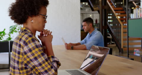 Focused Business Professionals Using Technology in Modern Office