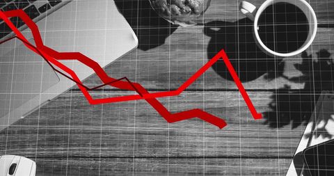 Declining graph over desk analyzing financial trends at work