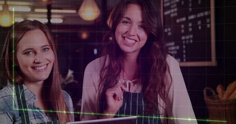 Smiling Baristas Behind Coffee Shop Counter Displaying Hospitality