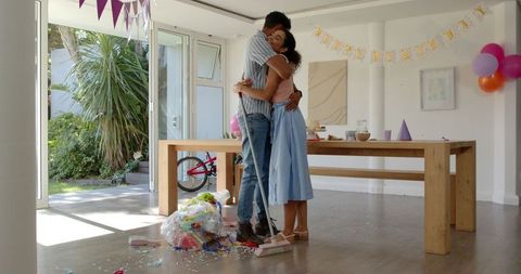 Loving couple embracing in decorated room after celebration