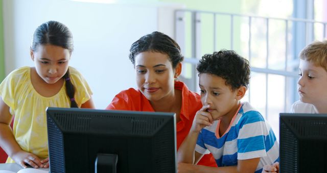 Teacher Assisting Young Students in Classroom with Computer Tasks - Download Free Stock Images Pikwizard.com