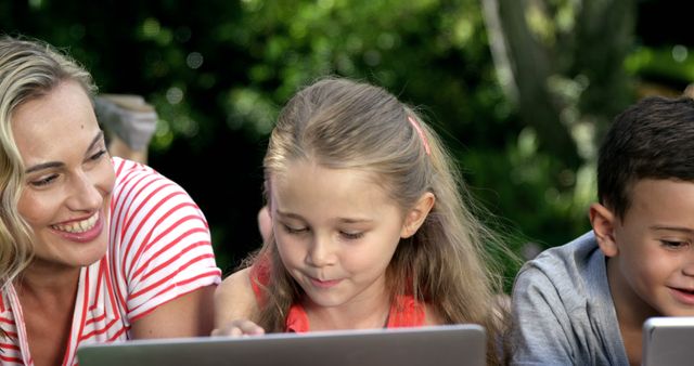 Mother Teaching Children on Tablets Outdoors - Download Free Stock Images Pikwizard.com