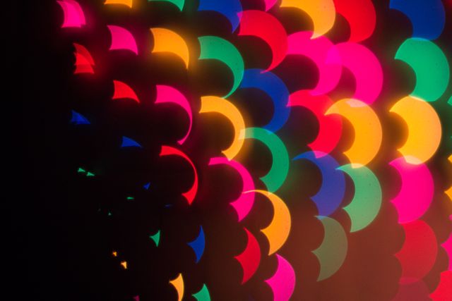 Abstract colorful light pattern featuring semi-circular shapes illuminated in vibrant colors. Perfect for backgrounds, creative designs, artistic projects, and digital media needing dynamic and eye-catching visuals.