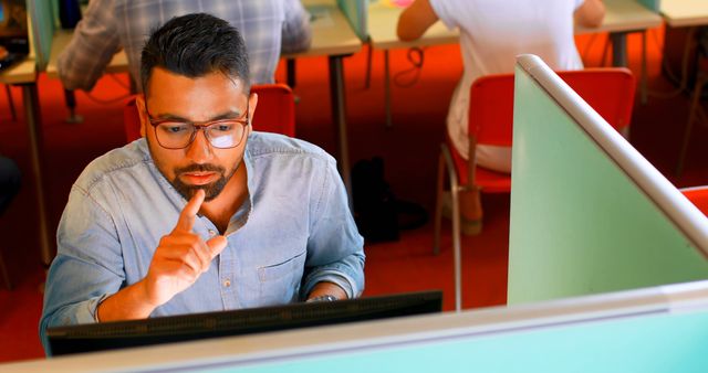 Focused Man Sitting at Desk in Open Office Using Computer - Download Free Stock Images Pikwizard.com