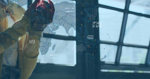 Pressing gloved finger on high-tech map interface in modern command center