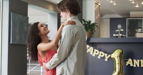 Joyful Multiracial Couple Celebrating Anniversary at Home Party