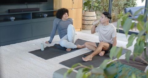 Diverse Friendship Relaxing Post-Yoga Rest Home Interior