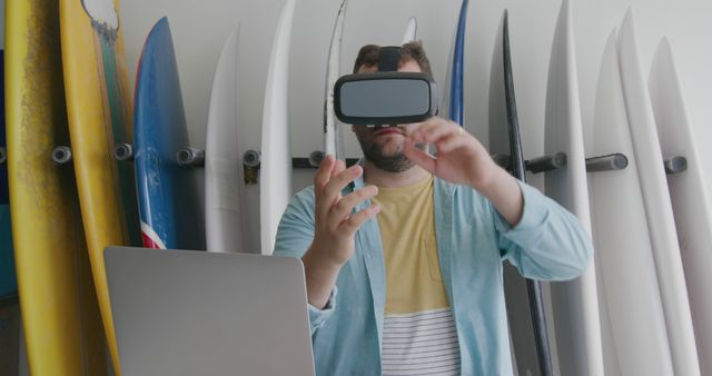 Man Experiencing Virtual Reality Surrounded by Surfboards - Download Free Stock Images Pikwizard.com