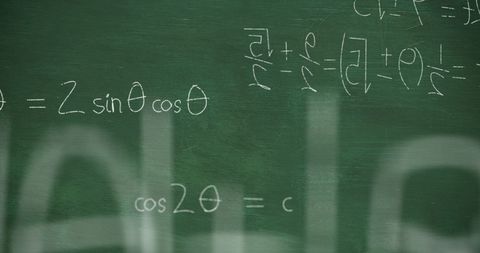 Mathematical equations on chalkboard with handwritten formulae