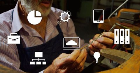 Craftsman wearing apron shaping metal ring in workshop with innovative icons