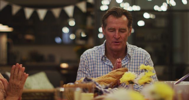 Senior Man Praying at Dinner Table with Family - Download Free Stock Images Pikwizard.com