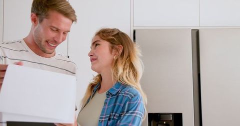 Couple Enjoys Preparing Breakfast Together in Modern Kitchen