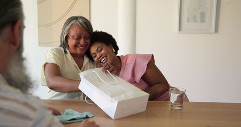 Diverse Women Joyfully Sharing a Gift Together