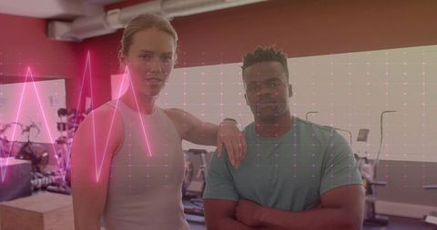 Fitness partners posing in modern gym with holographic ecg overlay for biometric training