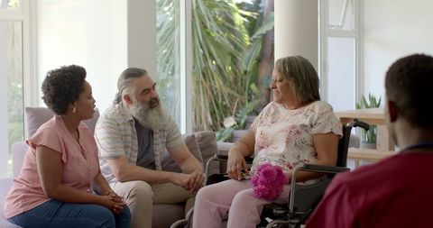 Diverse Group Sharing Moment with Elderly Woman in Wheelchair