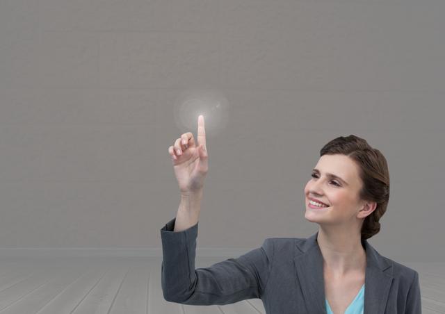 Digital composite of Businesswoman touching air with grey background