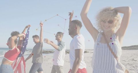 Joyful friends celebrating with american flag on sandy beach