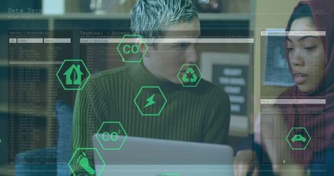 Colleagues collaborating on green technology project in modern office