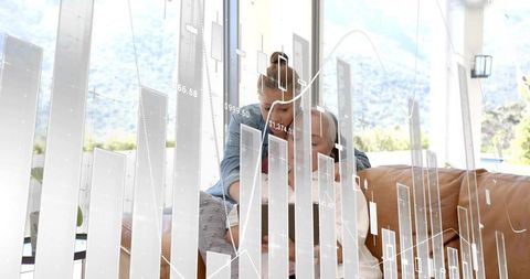 Mother and Teen Studying Finance on Tablet with Financial Charts and Sunlit Window Hills