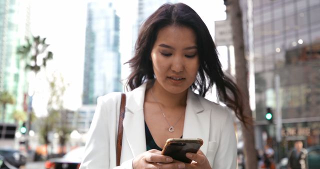 Businesswoman Checking Smartphone in Urban City - Download Free Stock Images Pikwizard.com