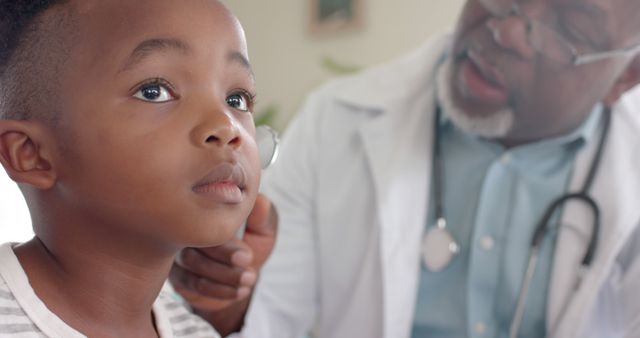 Pediatrician Examining Young Boy's Ear in Medical Office - Download Free Stock Images Pikwizard.com