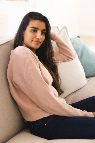 Asian Woman Relaxing on Sofa in Stylish Contemporary Living Room