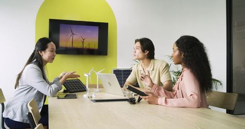 Diverse Team Discussing Renewable Energy in Modern Office