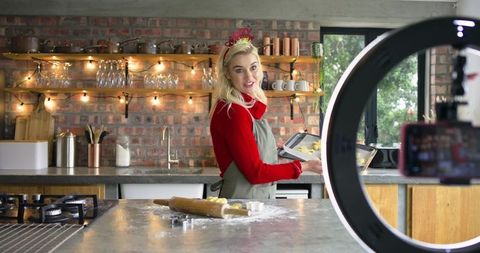 Baking Livestream Creator Filming Cookies with Ring Light in Cozy Brick Kitchen