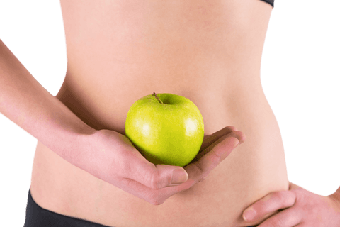 Fit woman holding green apple against transparent background