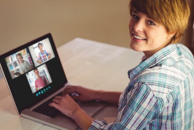 Smiling caucasian girl using laptop for video call, with diverse high school pupils on screen - Download Free Stock Photos Pikwizard.com