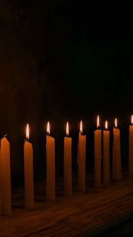 Vertical Panning Video Showing Flickering Wax Candles on Rustic Wood Ledge