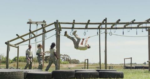 Team of soldiers training on obstacle course in nature