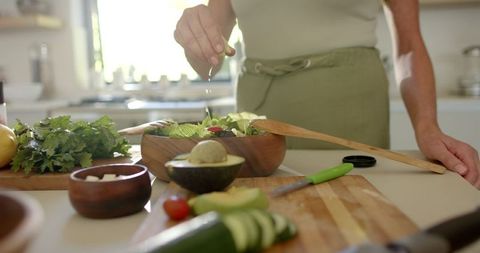 Woman Preparing Fresh Salad in Sunlit Kitchen - Download Free Stock Images Pikwizard.com