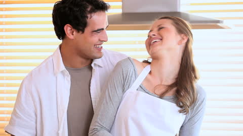 Happy Couple Enjoying Cooking Together in Kitchen