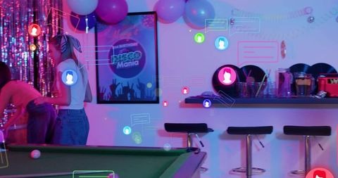 Standing woman watching pool table in neon disco lounge wearing bandana and jeans