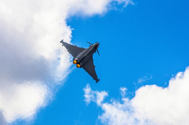 Military Fighter Jet Flying in Blue Sky with Clouds - Download Free Stock Photos Pikwizard.com