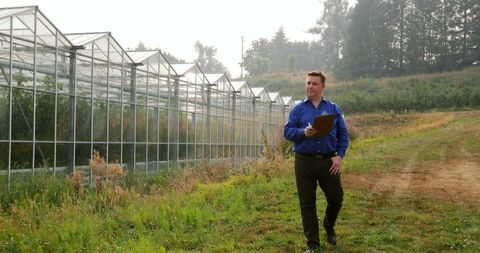 Manager Overseeing Agriculture Near Greenhouses - Download Free Stock Images Pikwizard.com