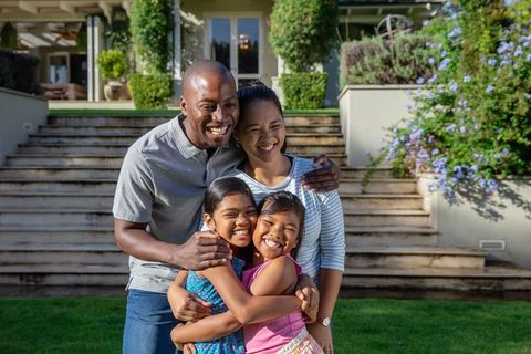 Diverse Family Embracing on Sunlit Lawn