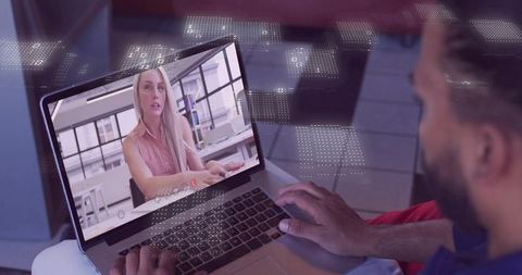 Man holding laptop while viewing remote video call woman speaking in modern workspace