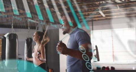Duet jumping rope in boxing studio with digital teal overlay, cardio training and focus