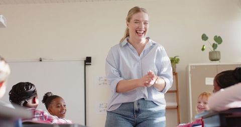 Smiling Teacher Engaging Young Students in Collaborative Classroom