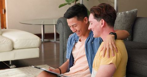 Diverse Gay Couple Celebrating Together at Home