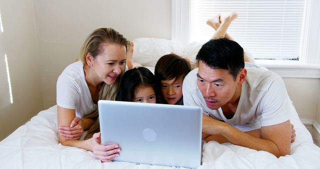 Happy Multiethnic Family Using Laptop in Bedroom - Download Free Stock Images Pikwizard.com