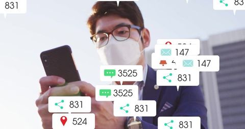 Asian Businessman Engaged with Smartphone Notifications in Urban Setting