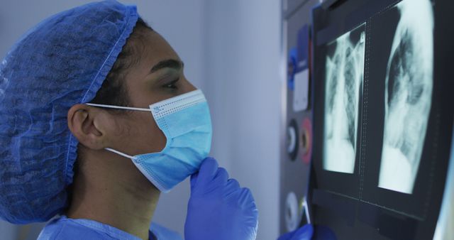 Healthcare Worker Analyzing X-ray Image with Protective Gear - Download Free Stock Images Pikwizard.com